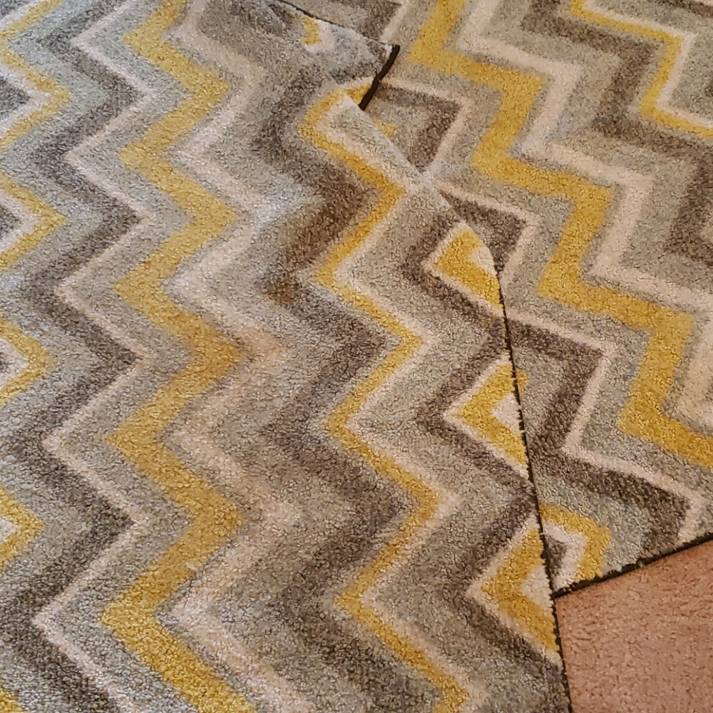 Yellow, grey, and white zig zagged rugs
